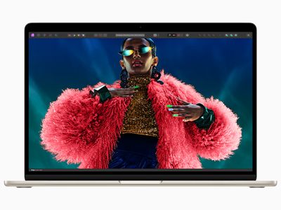M3 MacBook Air with a Black woman in an amazing pink fluffy jacket on the screen.